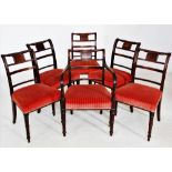 A set of nine George IV mahogany dining chairs, each with a concave rail back, the central rail