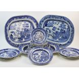 Three mid 19th century earthenware willow pattern meat plates, twelve willow pattern dinner