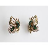 A pair of untested emerald and diamond earrings, mid 20th century, each of foliate form and set in
