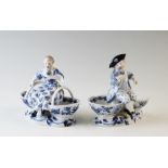 A pair of late 19th century Meissen blue painted double salts depicting a boy and a girl in