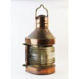A late 19th/early 20th century ships copper masthead lantern, with a brass swing handle above a