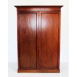A 19th century mahogany two door wardrobe, with a cavetto cornice above a pair of panelled doors