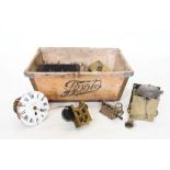 A collection of clock movements and parts to a vintage 'Boots' box, to include, an eight day
