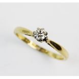 A diamond solitaire ring, the round brilliant cut diamond weighing approx. 0.10 carat, claw set in