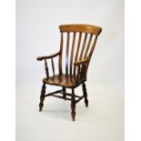A Victorian elm and beech wood Windsor farmhouse elbow chair, with a lath back above shaped seat,