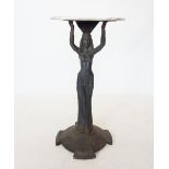 An Art Deco cast iron figural bar table, the later white marble circular top raised upon an iron