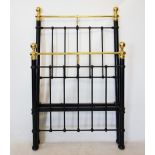 A Victorian style single bed, with brass ball finials and top rail, above the black painted frame,