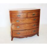 An early 19th century mahogany bow front chest of drawers, the cross banded top above two short
