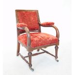A Victorian oak and upholstered library chair, the padded back within a fluted frame, above down