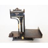 A set of early 20th century Japanned cast iron grocers scales by G.M James, Bath, with a cast
