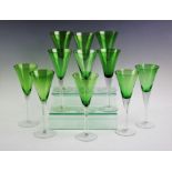 A matched set of eleven green glass flutes, each with clear glass stem and green bowl, 22.5cm