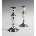 A pair of 'Empire Sterling' candlesticks, each of baluster form and raised on tapering circular