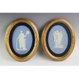 A pair of Wedgwood blue jasper cameo ware oval plaques, depicting Cupid and a further classical