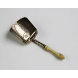 A George III silver caddy shovel, ?IT? Birmingham 1802, with turned ivory handle and shield