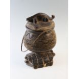 A carved zoomorphic Ashanti container and cover, the removable cover with a carved crocodile finial,