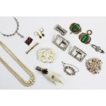 An assortment of vintage and costume jewellery, to include; a slave bangle, a green stone set