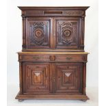 A late 19th century French oak cupboard, with a moulded and stepped cornice above a pair of cupboard