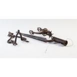 A selection of 17th century and later military ironworks to include a single spur, 20cm long, a