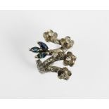 A diamond and sapphire abstract floral ring, designed as a blossoming branch issuing four diamond