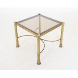 A mid 20th century brass coffee table, the square smoked glass top raised upon cylindrical brass
