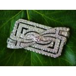 A diamond set Art Deco brooch, the rectangular brooch with central stylised bow 'twist', set