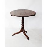 A George III oak tripod table, the circular tilting plank top raised upon a knopped baluster