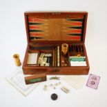 An early 20th century gaming compendium, the mahogany case enclosing a selection of games and