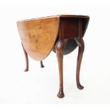 A George II mahogany drop leaf table, the oval top raised upon shell moulded cabriole legs with