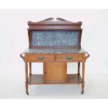 An Edwardian two piece oak bedroom suite comprising; a marble top washstand with a swan neck