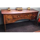A George III mahogany bow front sideboard, the central frieze drawer flanked by two deep drawers,