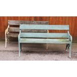 A near pair of Victorian cast iron and hardwood garden benches, the open work supports cast with