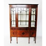 An Edwardian mahogany breakfront display cabinet, the frieze inlaid with interlaced stringing, above