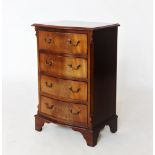 A reproduction George III style mahogany chest of drawers, 20th century, the serpentine cross banded