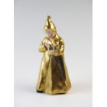 A Royal Copenhagen figure 'The Sandman' model number 1145, with gilt coat and hat, 16cm high