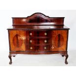 A 1920's mahogany Chippendale revival dining room suite comprising; an oval extending table with a