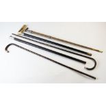 Five assorted walking sticks and canes, to include, a woven cane with wicker effect white metal