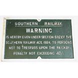 A reproduction cast iron railway sign, cast in relief with painted white text upon a green ground
