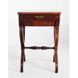 An early 19th century mahogany ladies work or stationery table, the hinged cover with fitted