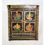 A painted Indian hardwood cabinet, 20th century, the pair of doors with two panels each applied with