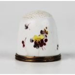A late 18th century Bilston enamel thimble, of typical form, the white ground decorated with