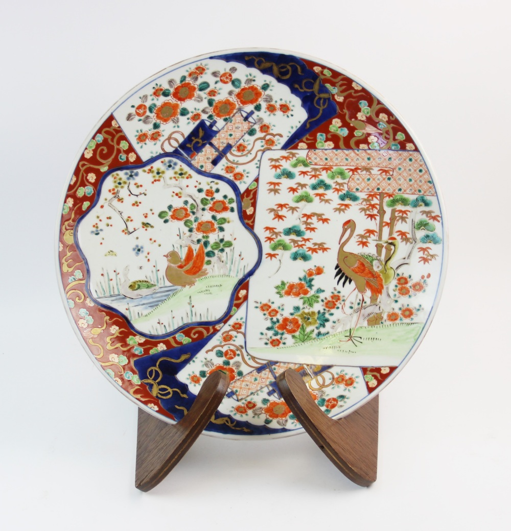 A Japanese Imari porcelain charger, Meiji period, decorated with panels of herons and birds,