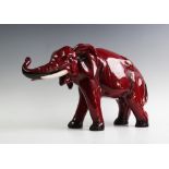 A large Royal Doulton flambe elephant, modelled with raised trunk, black printed mark to