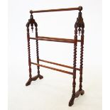 A Victorian mahogany Gothic influence towel rail, with sphere finials above arcaded brackets, raised