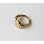 A 9ct yellow gold signet ring, the shield shape ring with decorative shoulders, weight 9.3gms
