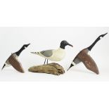 A vintage carved wooden sculpture modelled as a stylised seagull, 20th century, the body set on