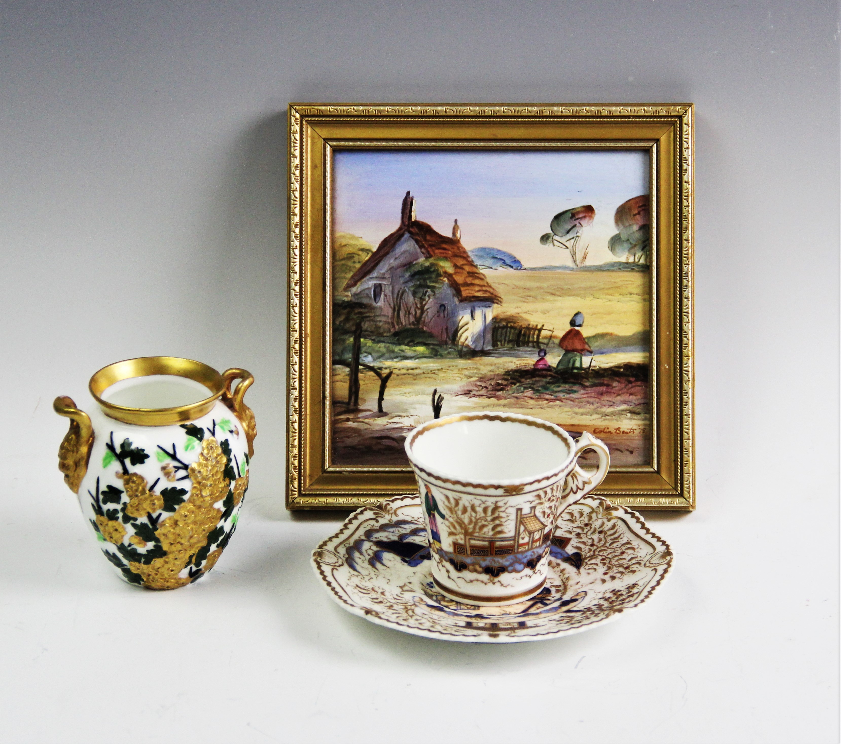 An early 19th century tea cup and saucer, probably Chamberlains Worcester, hand painted in an