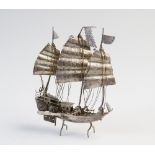 A Chinese silver filligree junk, the three masted ship, upon integral stand, 66gms, 13cm high (at