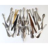 A collection of seventeen silver and white metal handled shoe horns, Victorian and later, each