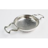 A George II silver lemon strainer, London 1748, of typical form with quatrefoil pierced shallow bowl