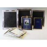 A collection of seven silver plated frames, to include plain polished and decorative examples,